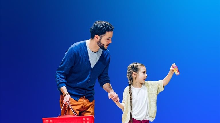 Father and daughter shopping in store. Girl is picking food product in supermarket. They are in casuals.