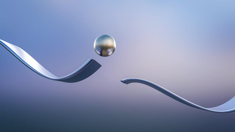 Metal ball jumping over interruption of wavy track