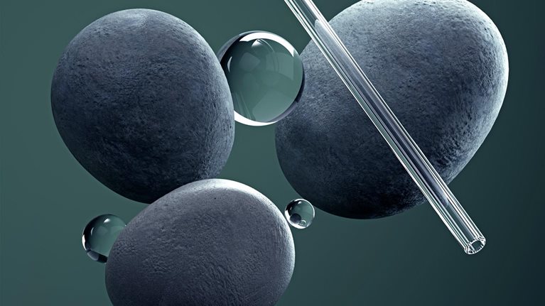 Digital generated image of a small glass spheres and pipes balancing on circular stones on green background