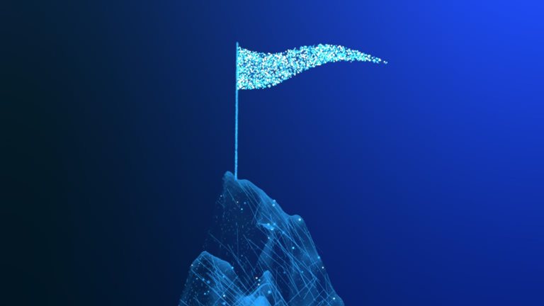 Animated blue particles form a mountain peak against a dark background. A flagpole rises from the summit, and a glowing blue flag waves as small particles drift away.