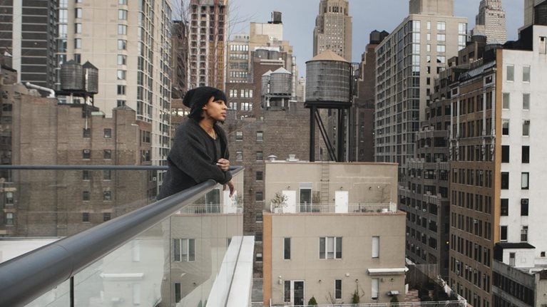 Woman looking out to cityscape
