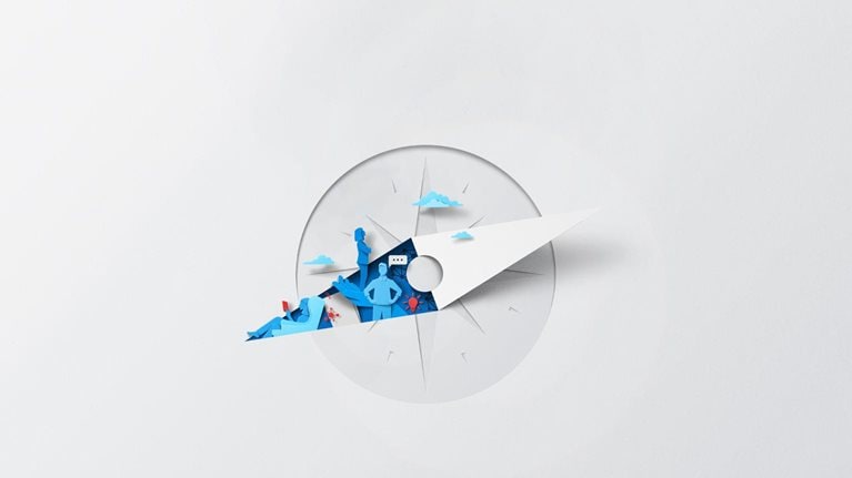 A white sheet of paper has been cut and folded, creating the silhouette of a compass. Inside of the compass needle are vibrant blue and red color shapes depicting various aspects of leadership and it’s innovative and collaborative nature with symbols of communication and ideas.