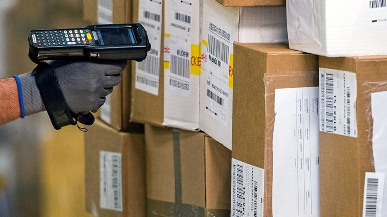 Male worker scanning barcode at warehouse