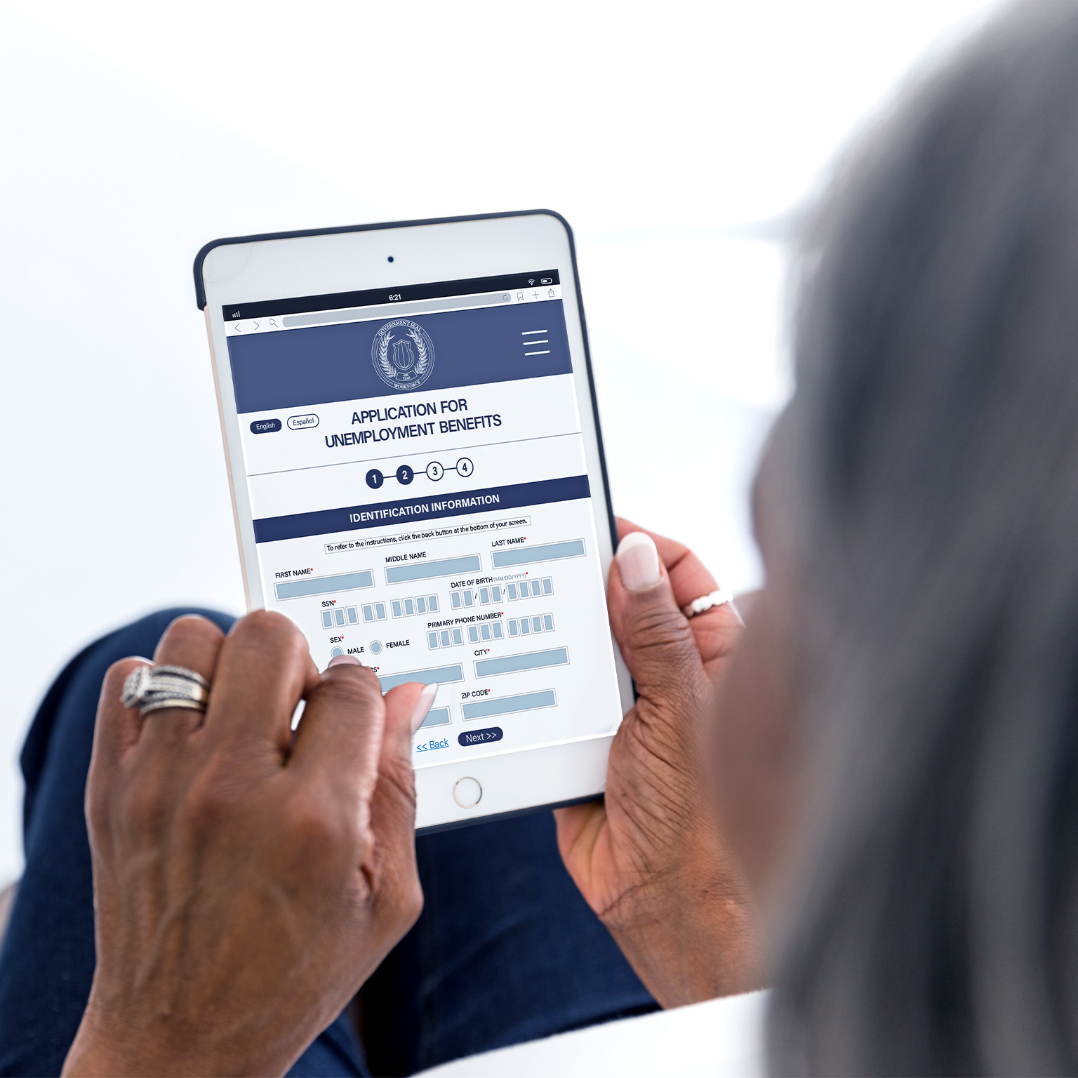 Woman filling out unemployment benefits form on her tablet