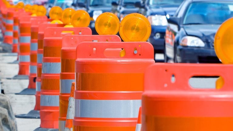A row of bright orange construction barriers