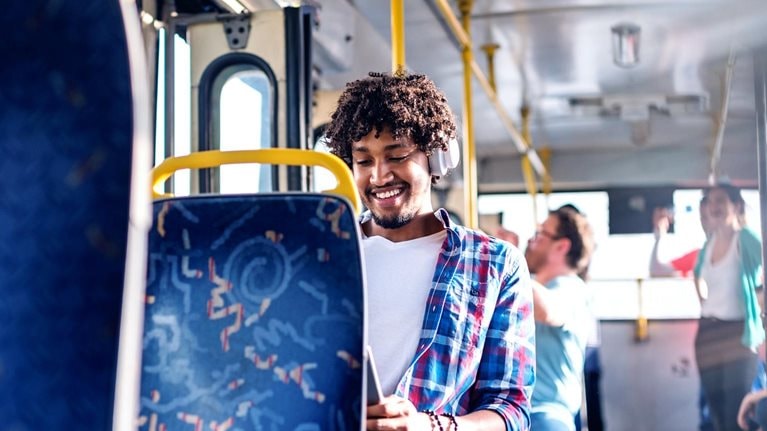 Smiling man on public transportation