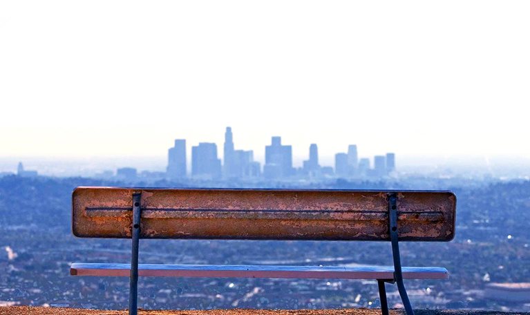 Empty bench facing the city