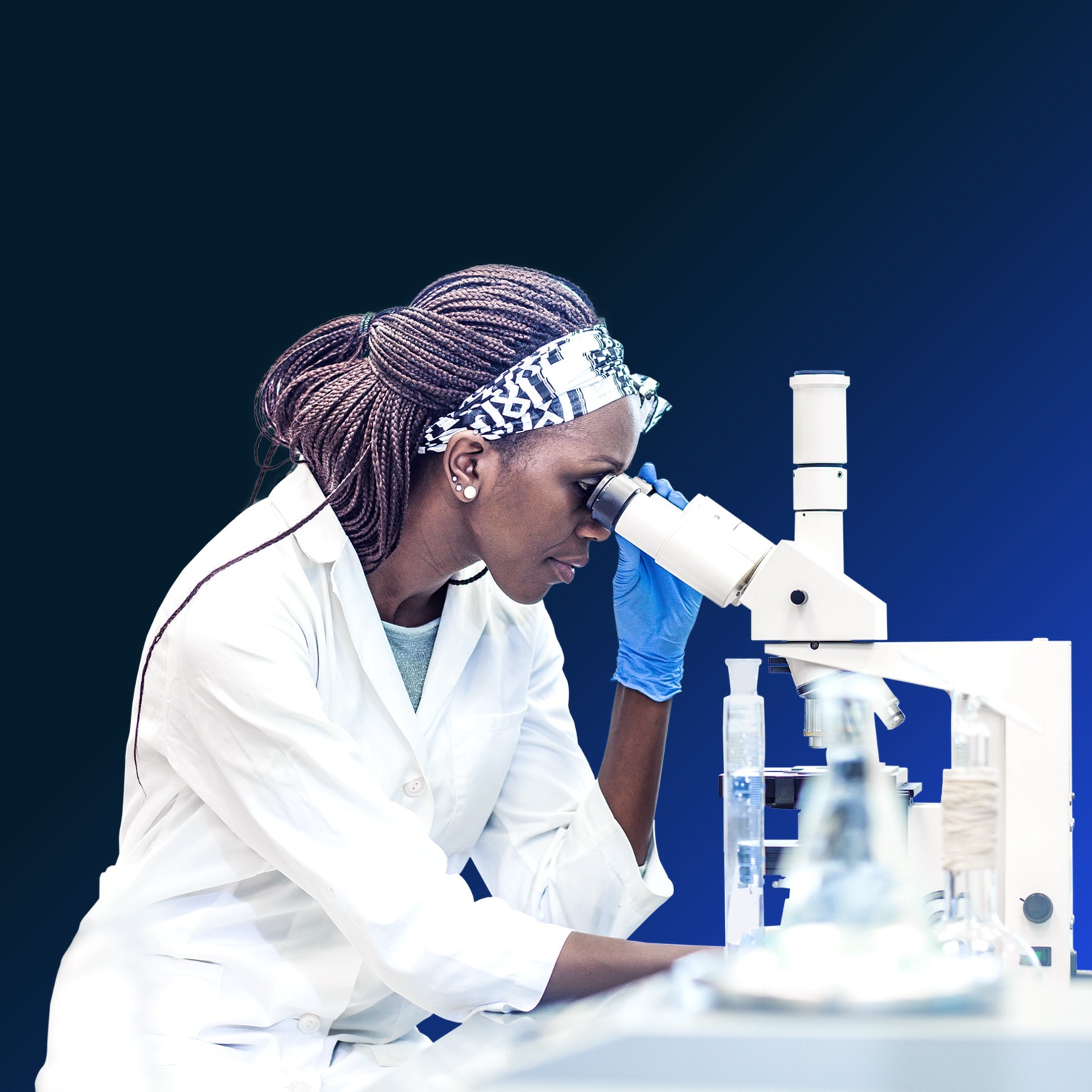 Female scientist working in the laboratory, using a microscope