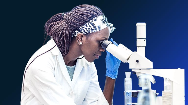 Female scientist working in the laboratory, using a microscope