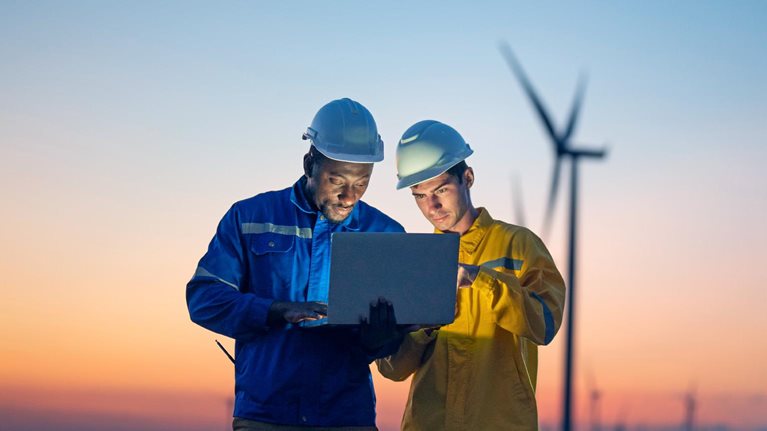 Maintenance engineer team working on wind turbine farm