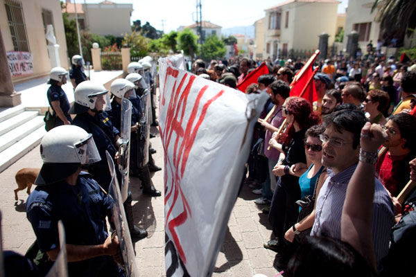 A standoff between police and demonstrators in Greece: rising debt-to-GDP ratios and expanded demands for government services will raise political tensions in the developed and developing worlds alike.