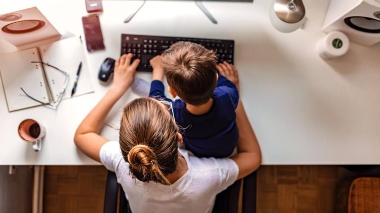 Young mother working from home - stock photo
