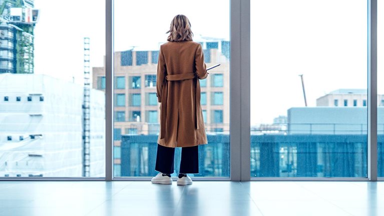 Businesswoman looking out window in meeting room