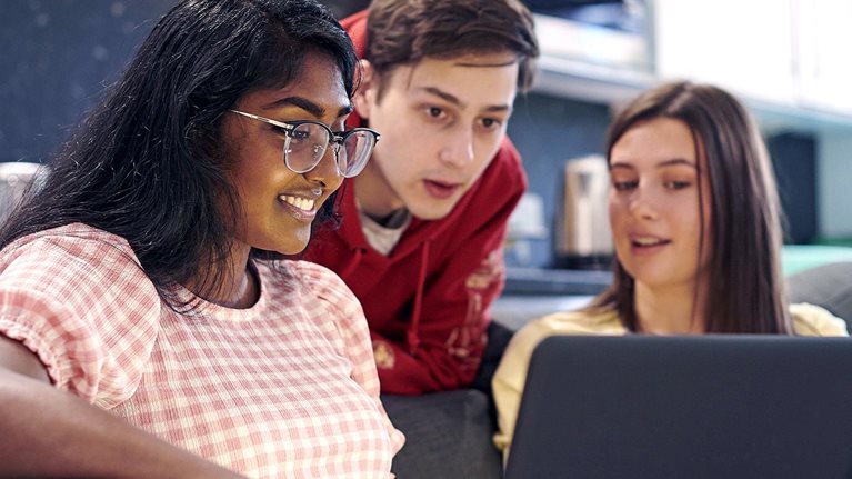 Friends hanging out together and chatting in university housing.