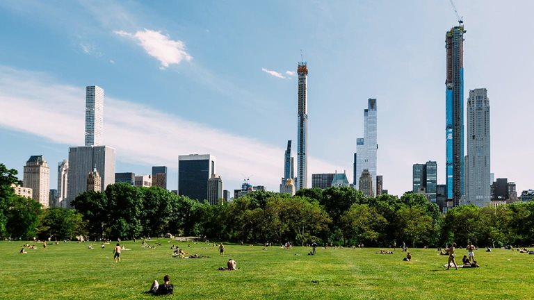 Green lawn at Central Park and Manhattan skyline