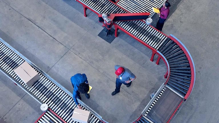 Male and female worker working at conveyor belt