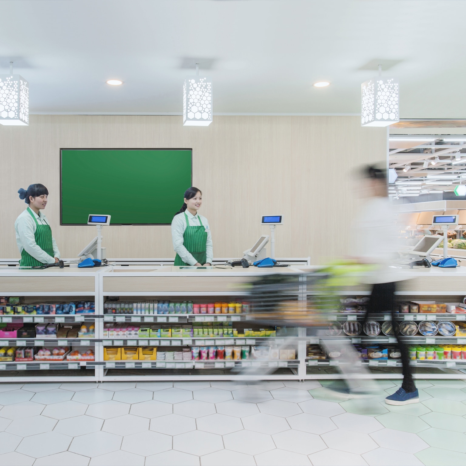 Supermarket staff standing at check-out counter
