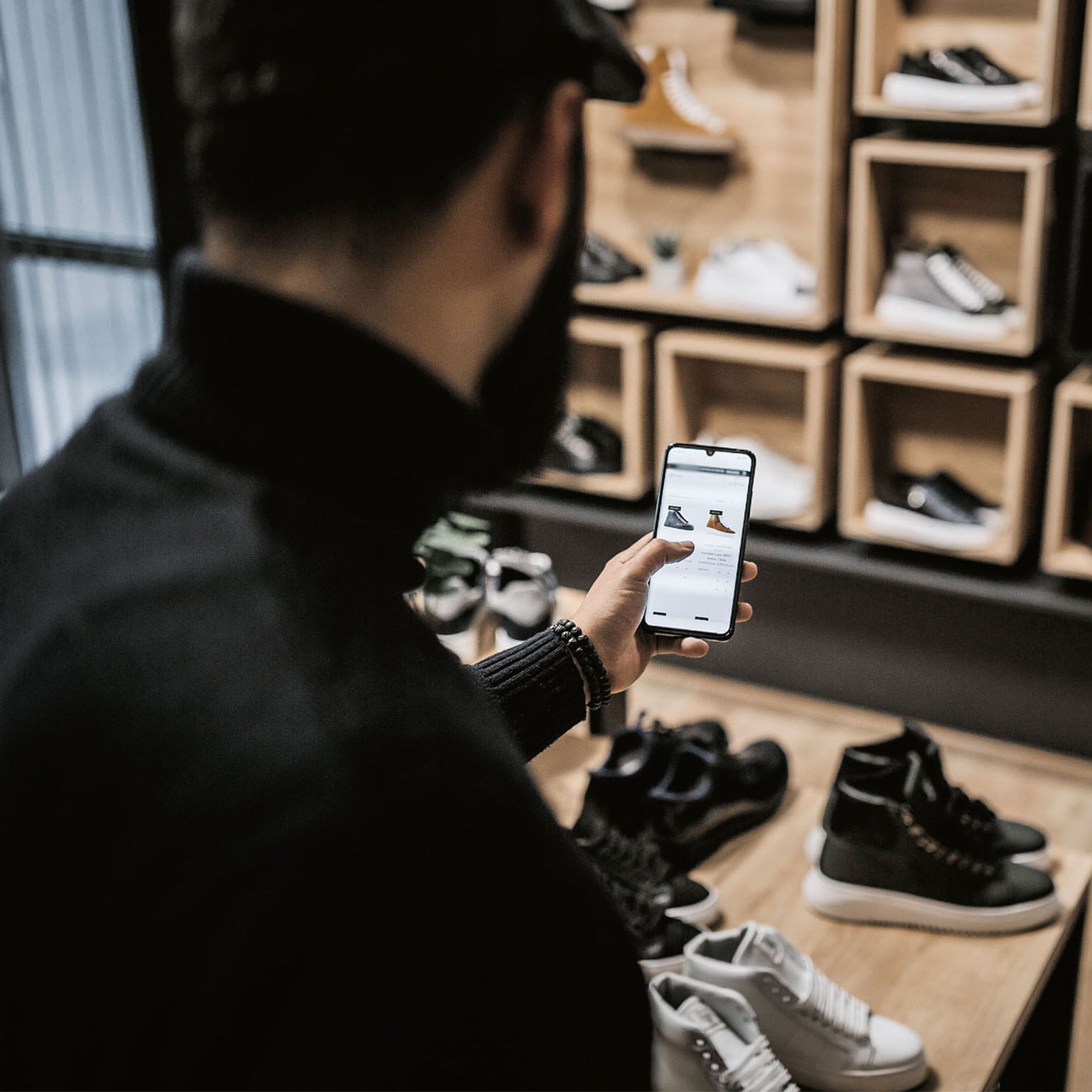 Person viewing an online shop on a mobile phone