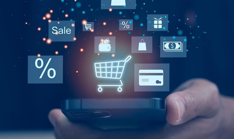 Hand holding a smartphone displaying floating shopping and payment icons, including a cart, discount symbol, and credit card.