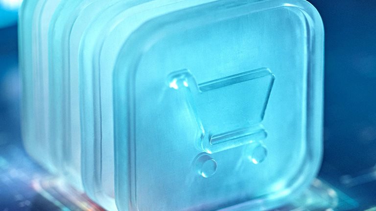 A digital shopping cart icon is illuminated in a futuristic blue light, symbolizing technology and e-commerce advancements