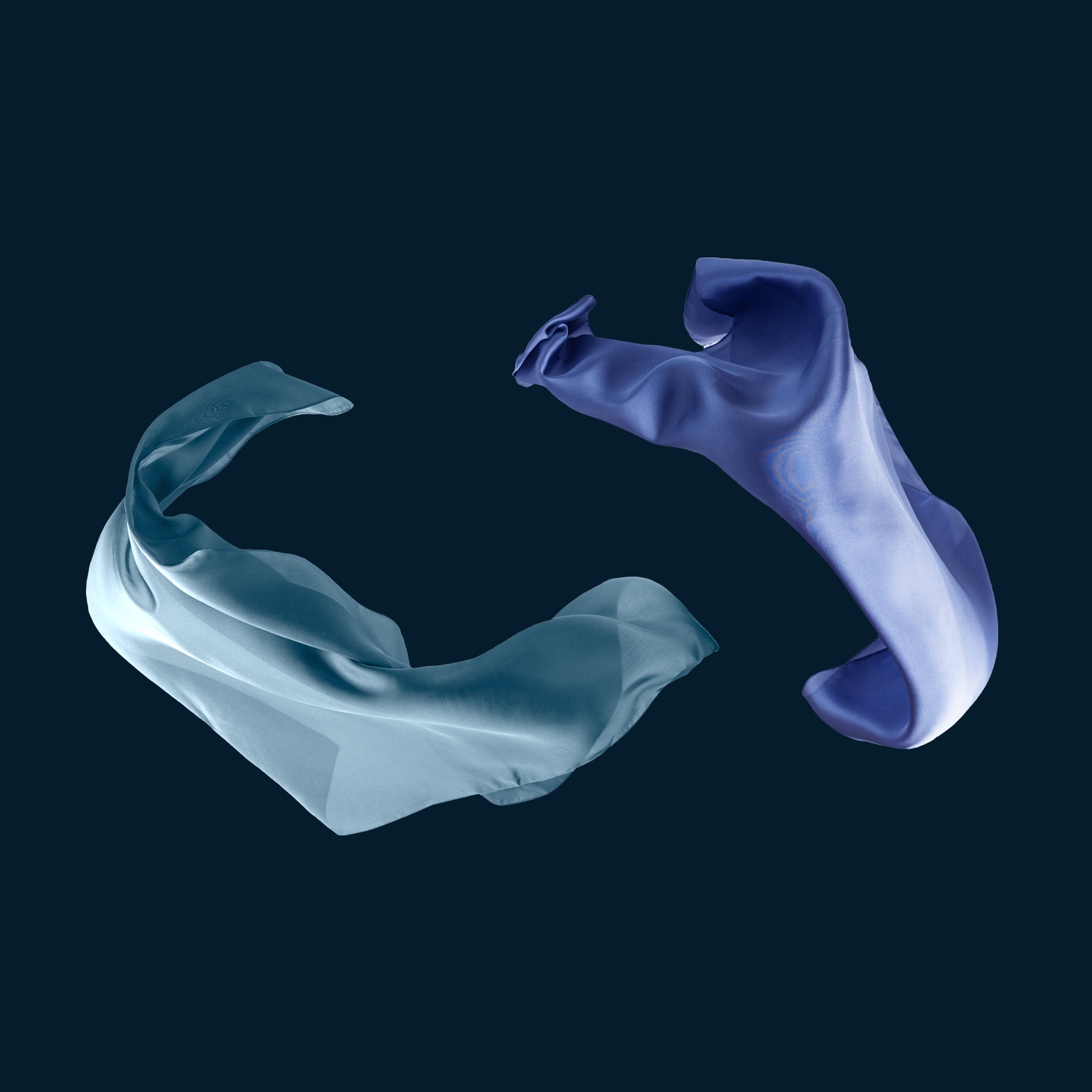 Flowing blue silk scarf isolated on black background