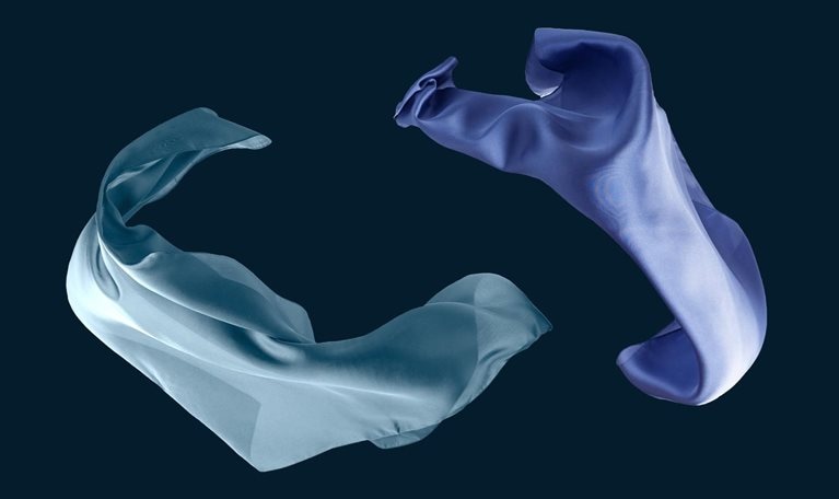 Flowing blue silk scarf isolated on black background