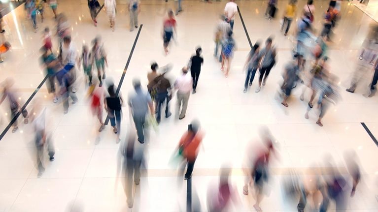 Crowd of people walking through a shopping mall