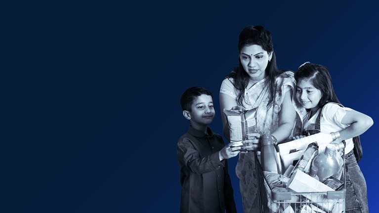 Indian mother and children with a cart full of groceries