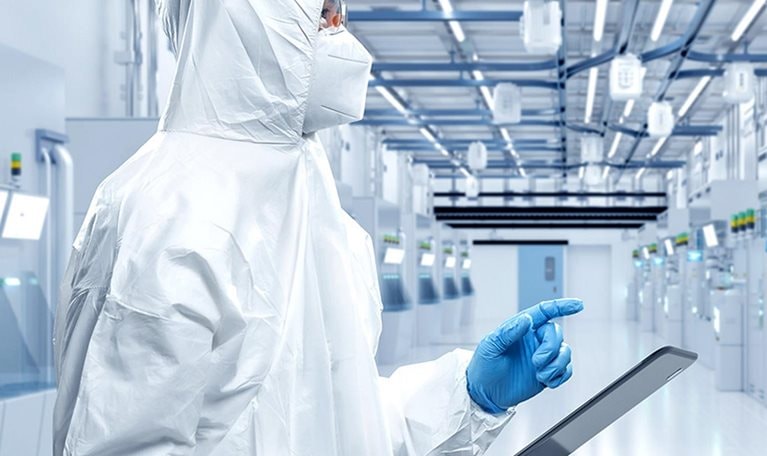 Worker or engineer wears protective suit or coverall suit work in semiconductor manufacturing factory.