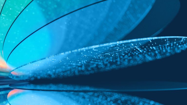 An abstract close-up of layered, translucent curved silicon wafer like forms in shades of blue, teal, and pale orange, with glowing dotted textures along their surfaces. The shapes overlap and reflect across a dark blue background.