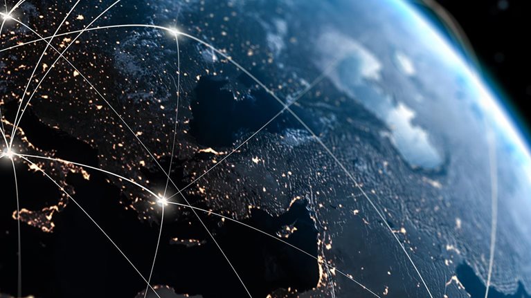 View of Earth from space with glowing lines of interconnectivity across globe.