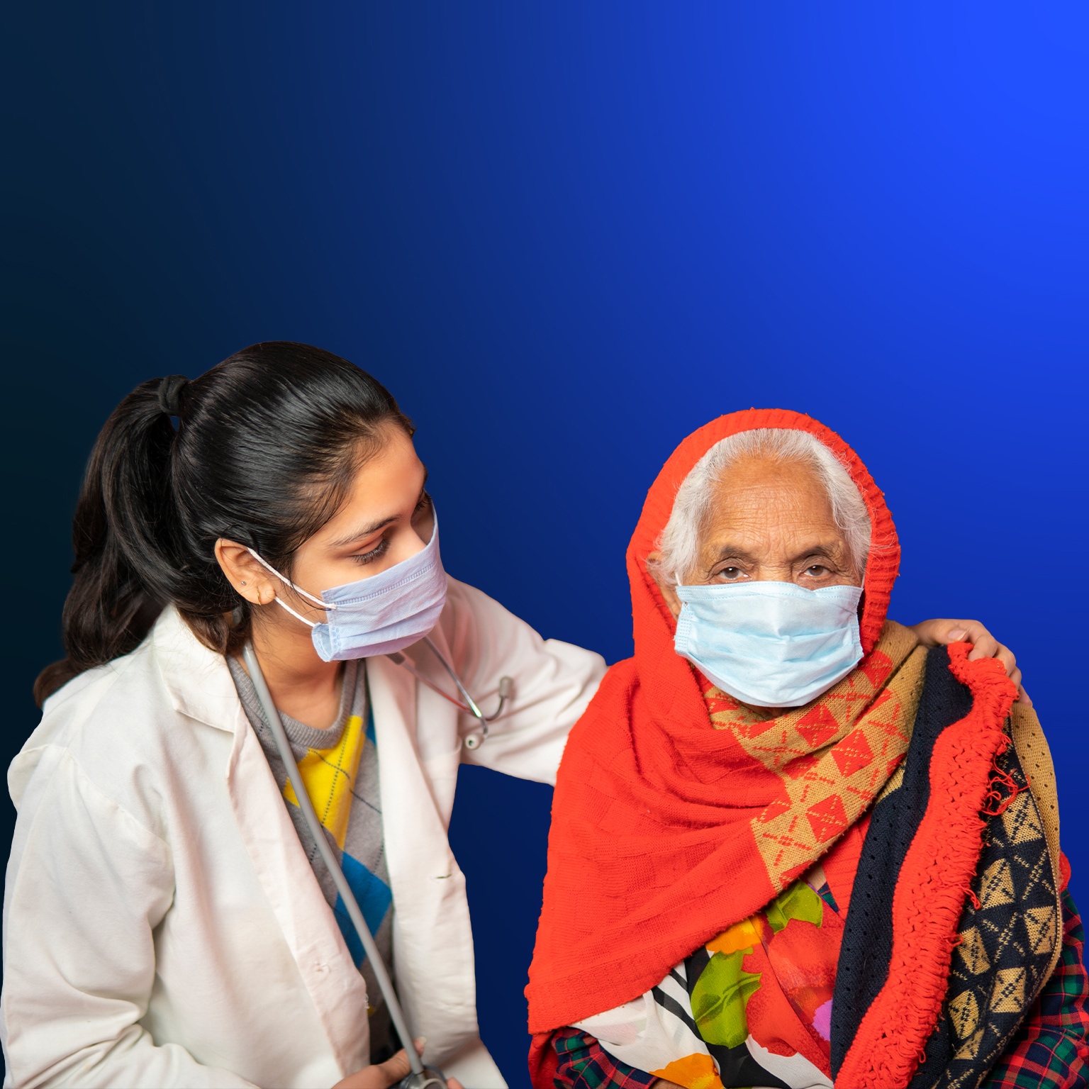 Indian female doctor comforting and giving mental support to senior woman patient at home.
