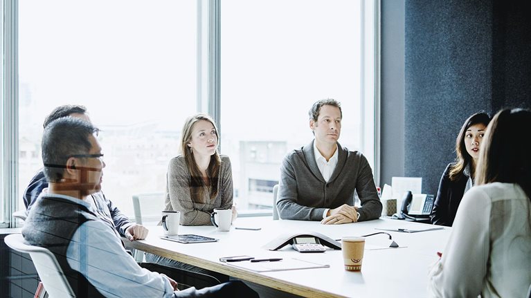 Coworkers in morning meeting in conference room