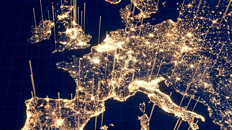 From a space perspective, Europe can be seen at night with clusters of golden dots representing city lights. Additionally, golden lines emanate from these urban regions, indicating the presence of technology and communication.