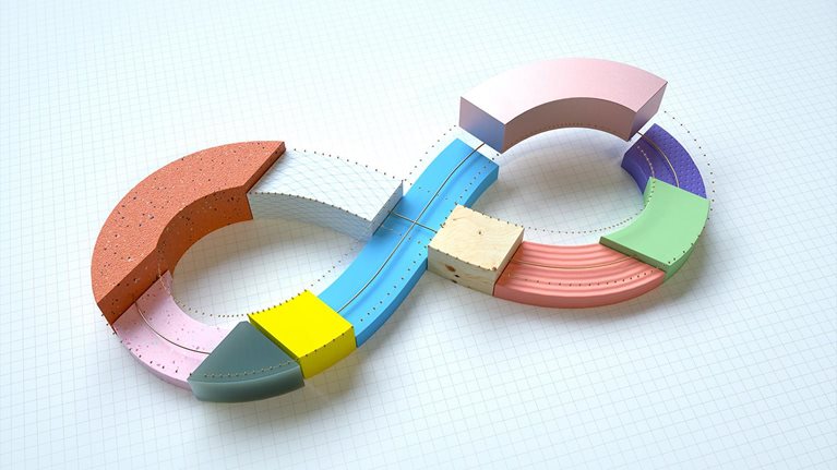 Abstract 3d infinity symbol made up of connected parts with a part being added.