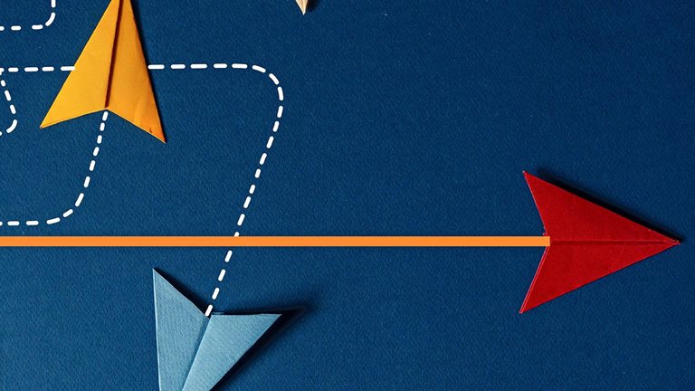 An image shows a group of multicolored paper planes tracing dotted lines in a swirling pattern, while a lone red paper plane rests at the end of a straight line.