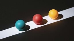 A illustration of three spheres on a white strip