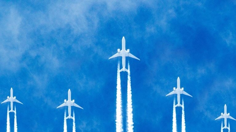 Photorealistic illustration of planes flying across the sky