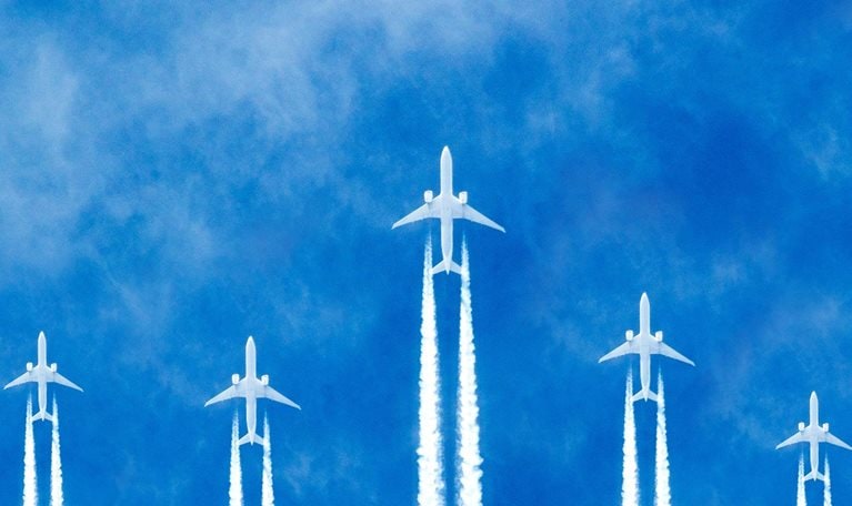 Photorealistic illustration of planes flying across the sky