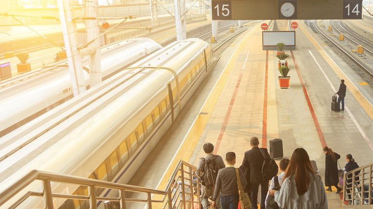 photo passengers walking down steps to train platform