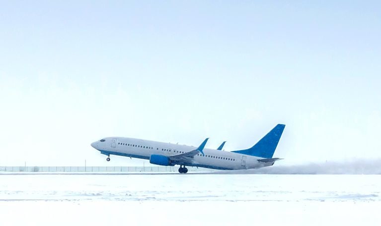 Takeoff of a passenger jet plane in a severe snowstorm