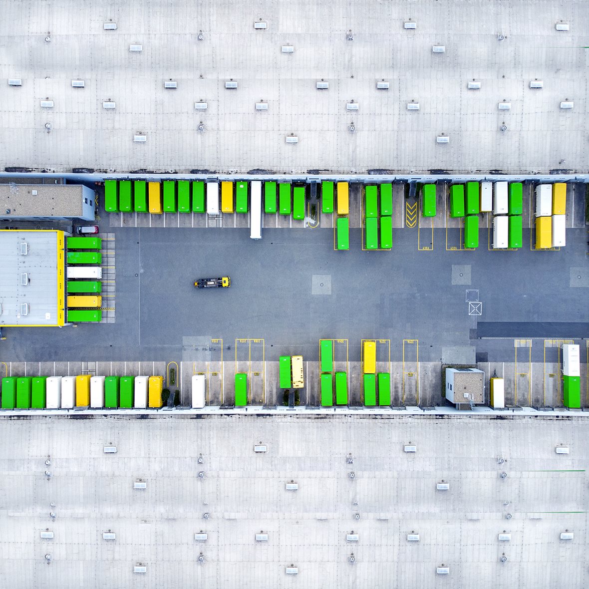 Aerial view of a distribution logistics building parking lot.