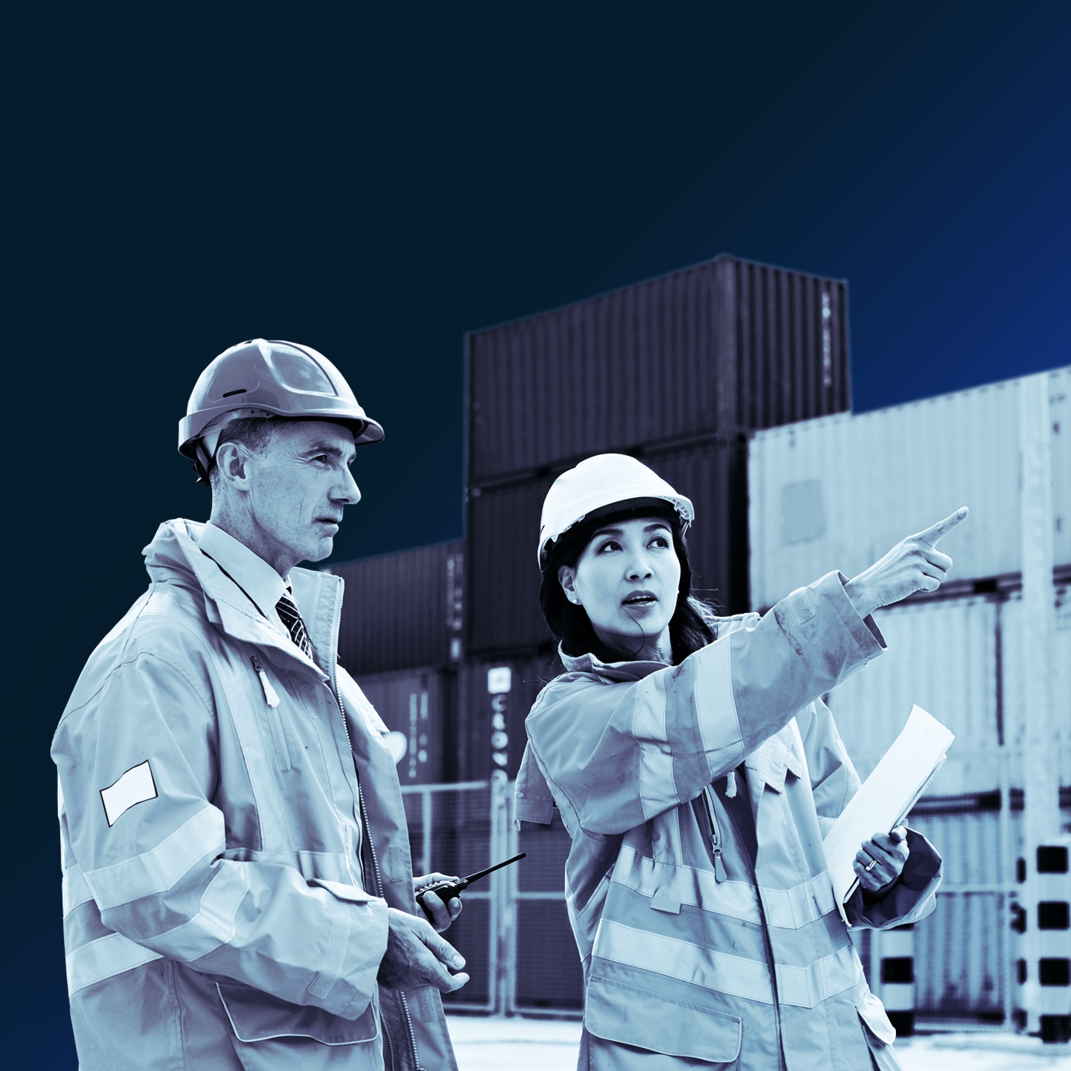 Two dock workers talking together while standing in a dockyard