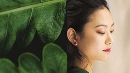 green leaves blending into side of woman's face - stock photo