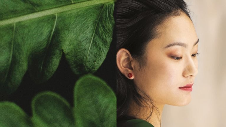 green leaves blending into side of woman's face - stock photo