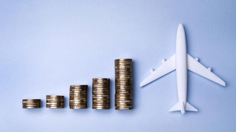 Stacks of coins next to a small model plane