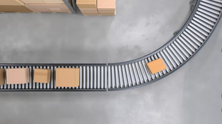 Top view of conveyor belts transporting boxes in a large warehouse - stock photo