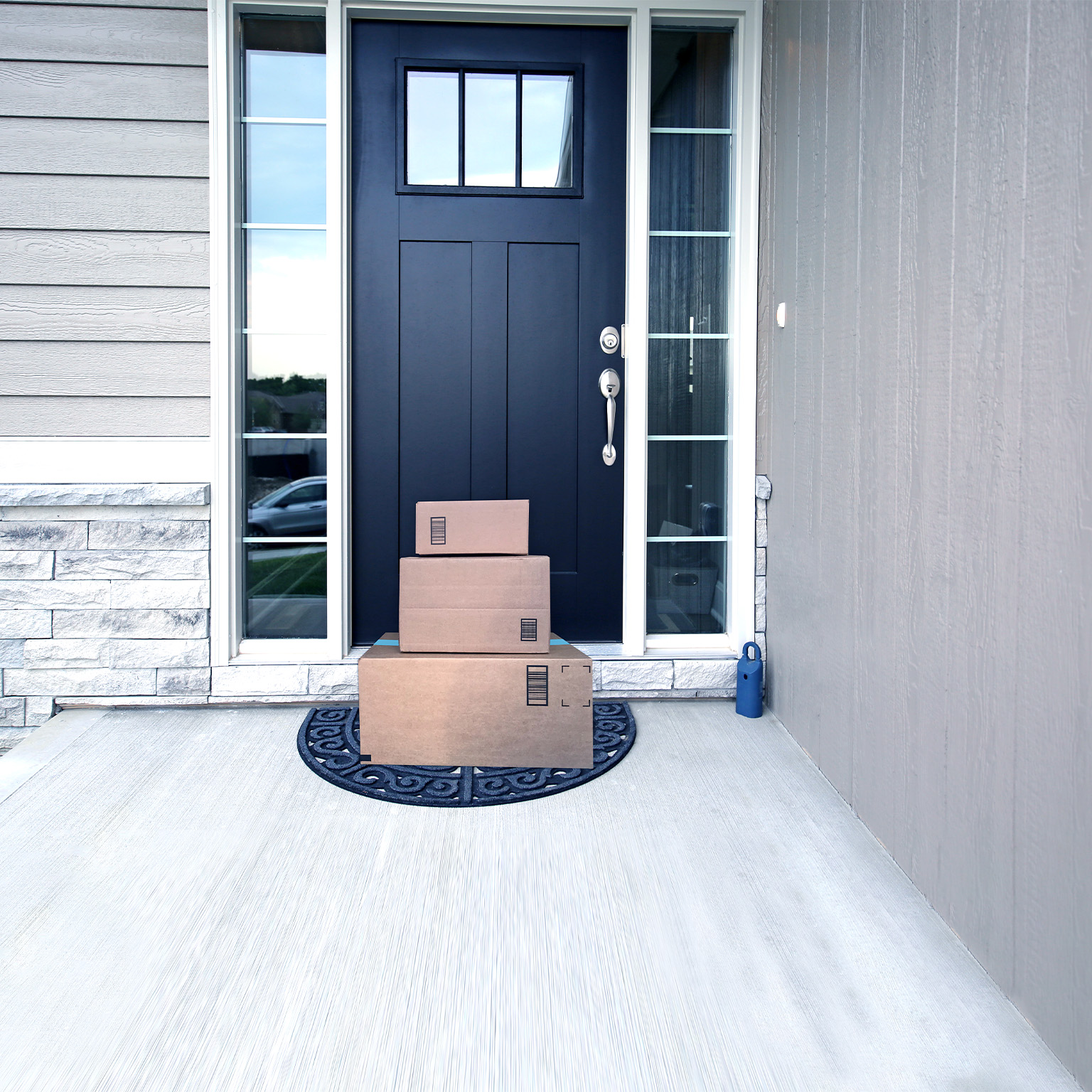  Image of packages neatly stacked in front of door.