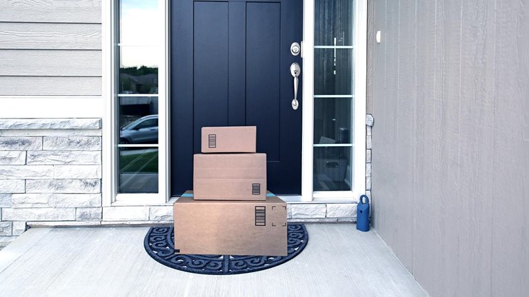 Image of packages neatly stacked in front of door.