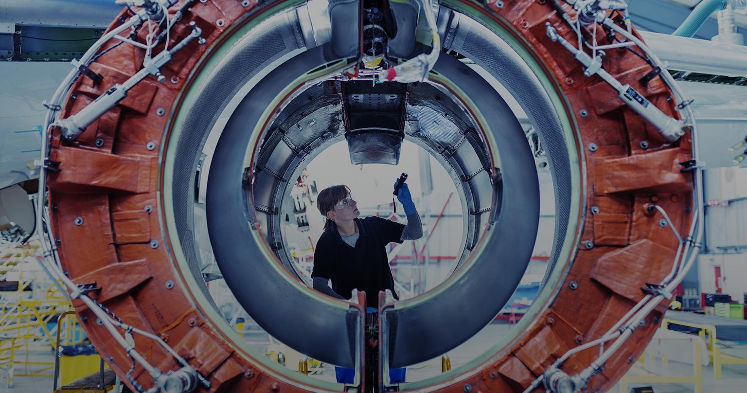 Aircraft maintenance engineer inspecting jet engine